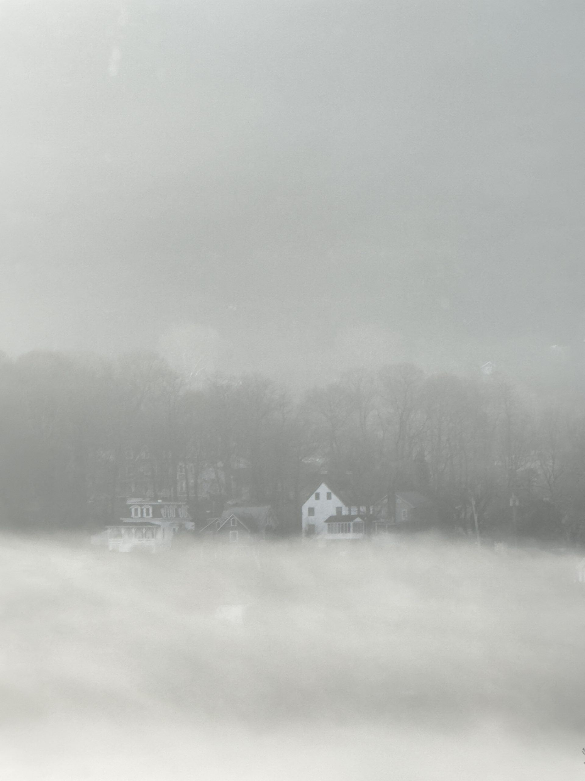 View of a house lost in fog over the Hudson River as seen from the Garrison Institute